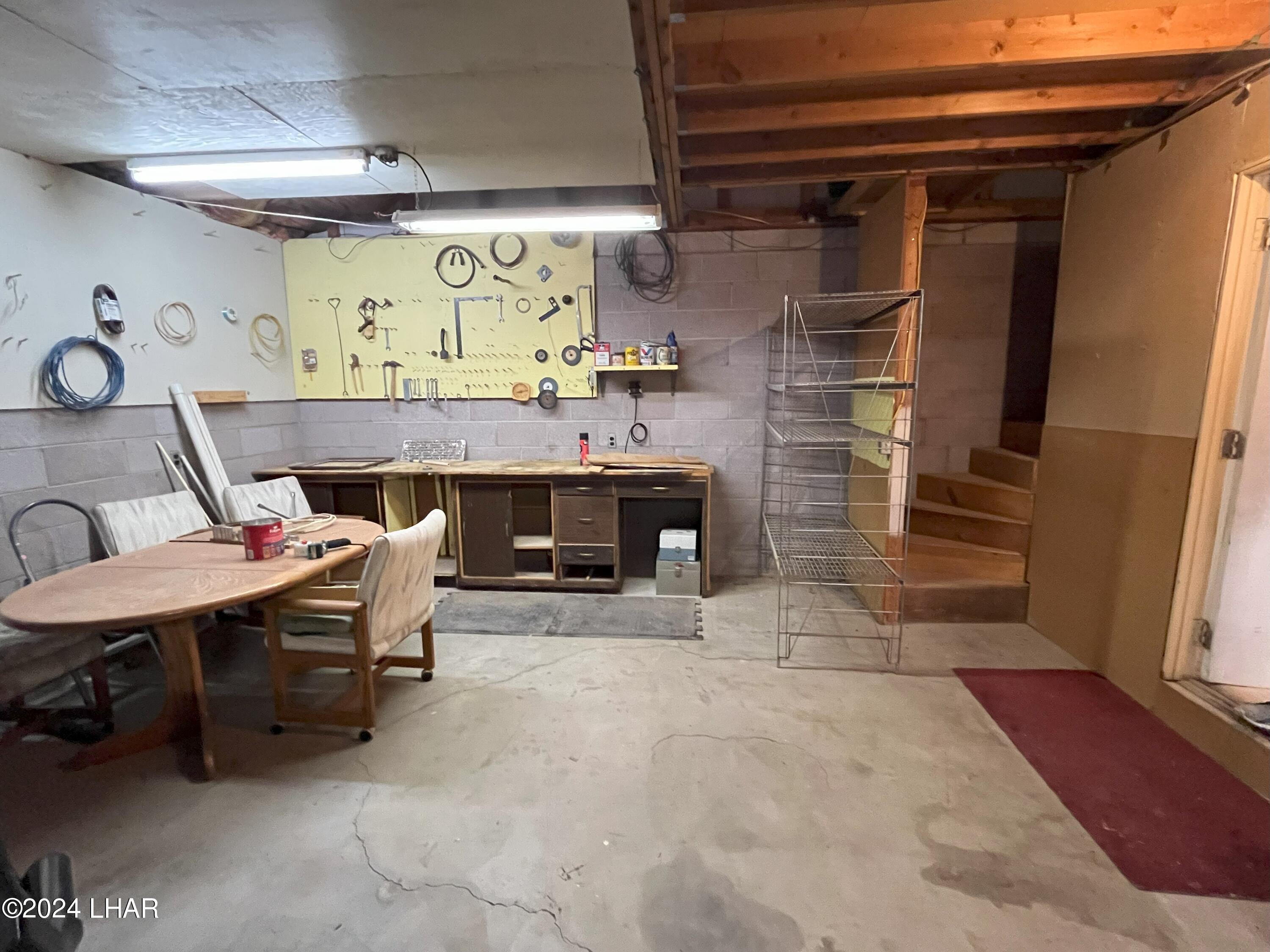31921 Cienega Springs Road Parker, AZ 85344 - Photo 36 of 40 Garage - Workbench and stairs to Loft