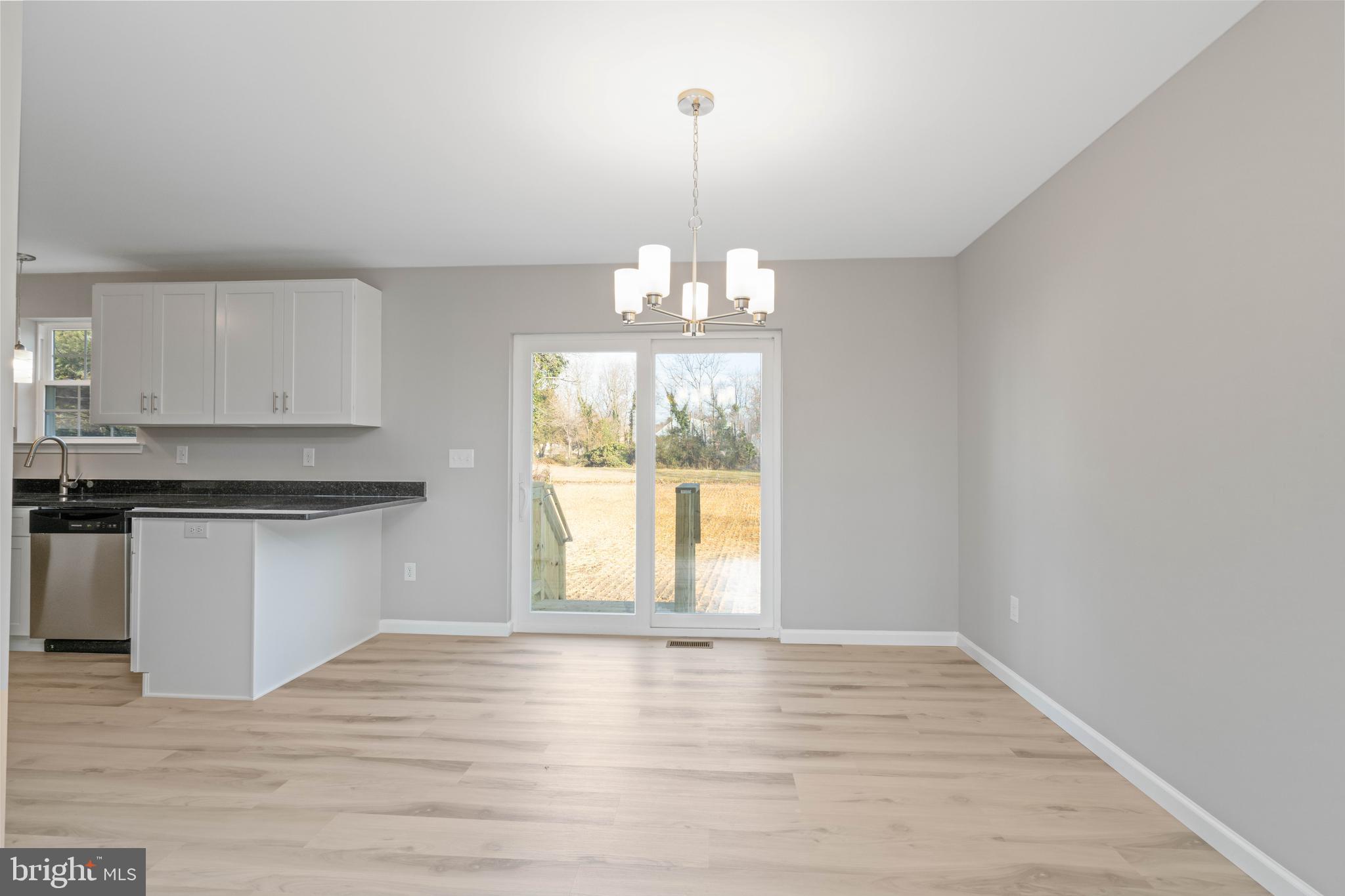 252 Stanger Avenue Glassboro, NJ 08028 - Photo 12 of 27 a view of an empty room with wooden floor and a window