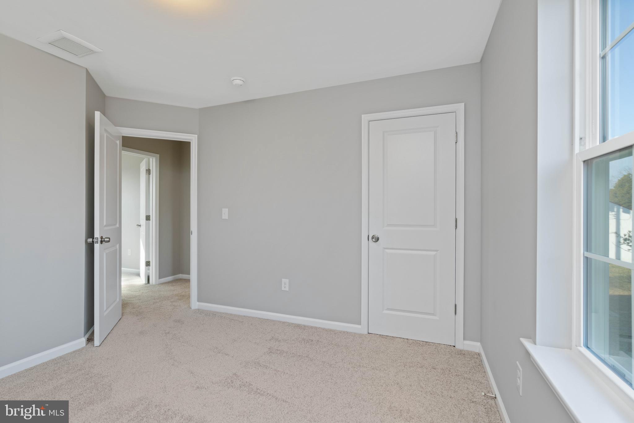 252 Stanger Avenue Glassboro, NJ 08028 - Photo 19 of 27 a view of an empty room with closet and a window