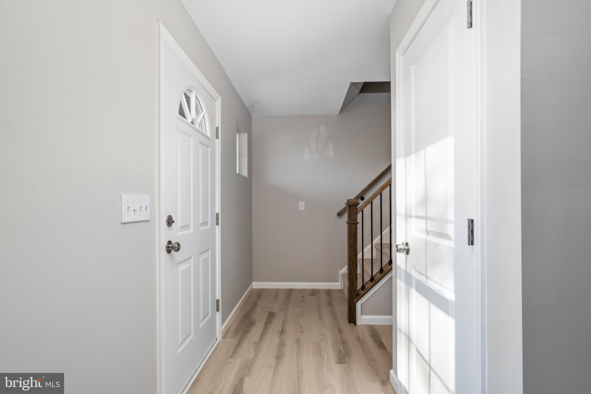 252 Stanger Avenue Glassboro, NJ 08028 - Photo 4 of 27 a view of a hallway with wooden floor and staircase