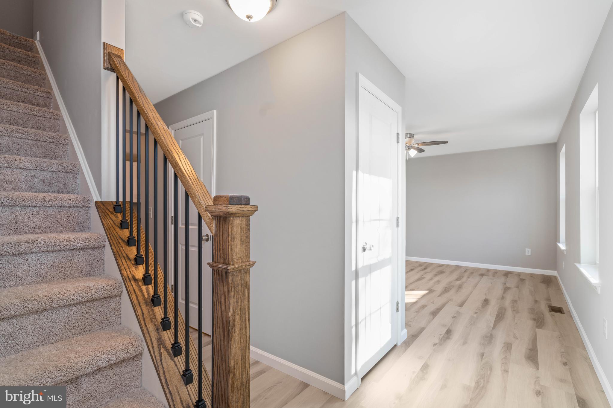 252 Stanger Avenue Glassboro, NJ 08028 - Photo 5 of 27 a view of a hallway with wooden floor and staircase