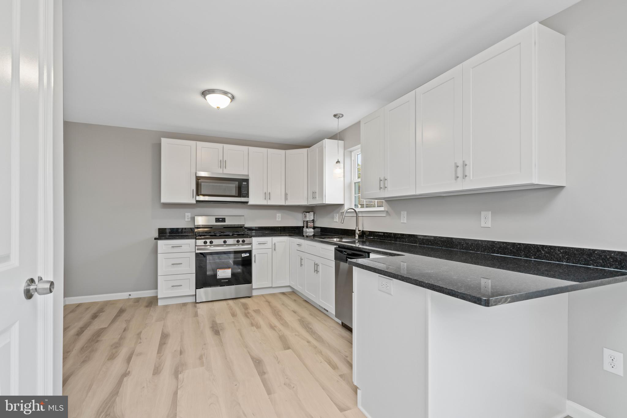 252 Stanger Avenue Glassboro, NJ 08028 - Photo 9 of 27 a kitchen with granite countertop white cabinets and white appliances
