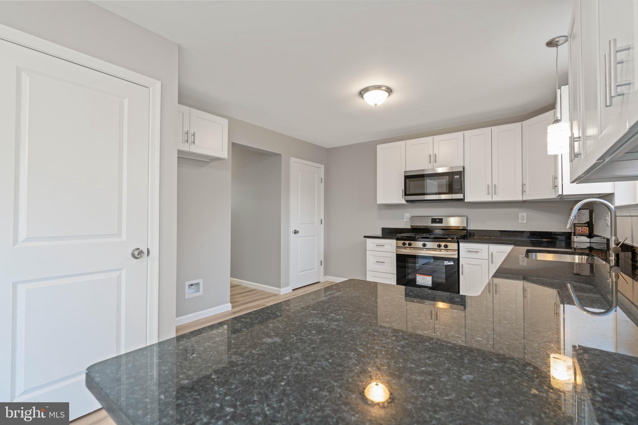 252 Stanger Avenue Glassboro, NJ 08028 - Photo 10 of 27 a kitchen with stainless steel appliances granite countertop a refrigerator a stove top oven a sink and dishwasher