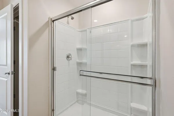 a bathroom with a glass shower door