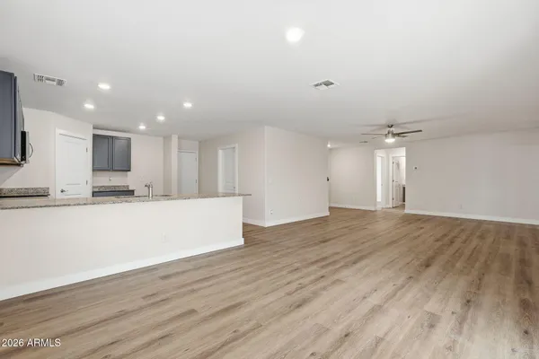 a view of kitchen with kitchen island wooden floor center island and stainless steel appliances