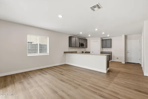 a view of kitchen with cabinets microwave and stove