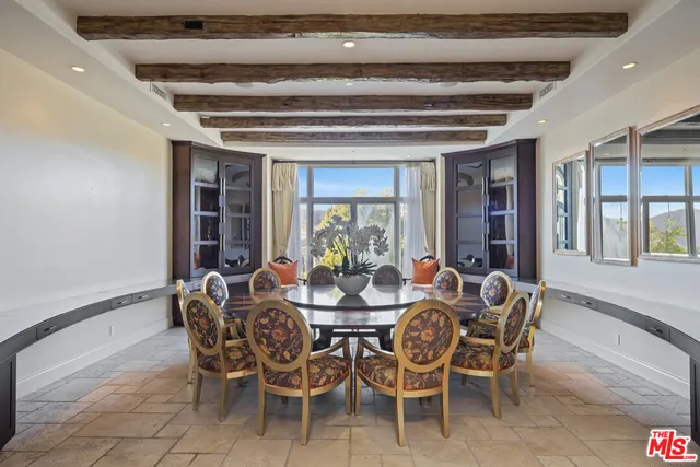 a bedroom with bed and a large window