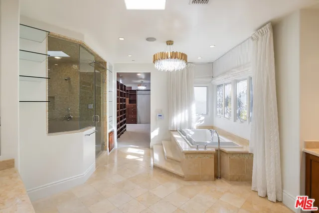 a bedroom with a large bed and a book shelf
