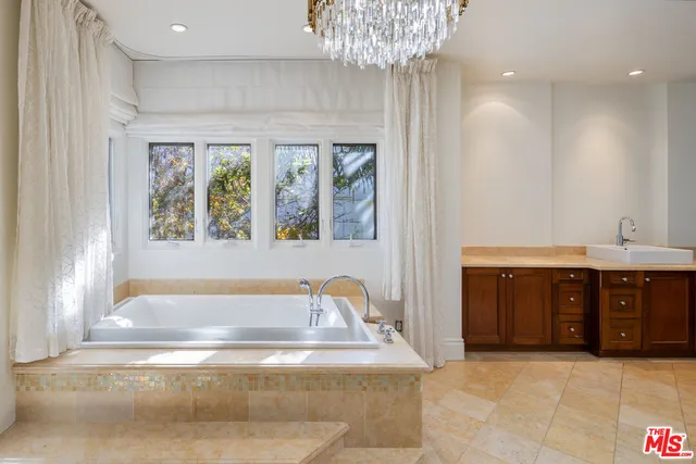 a bathroom with a granite countertop sink a toilet and shower