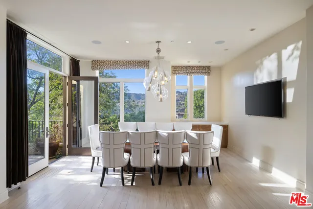 a spacious bathroom with a tub sink and mirror
