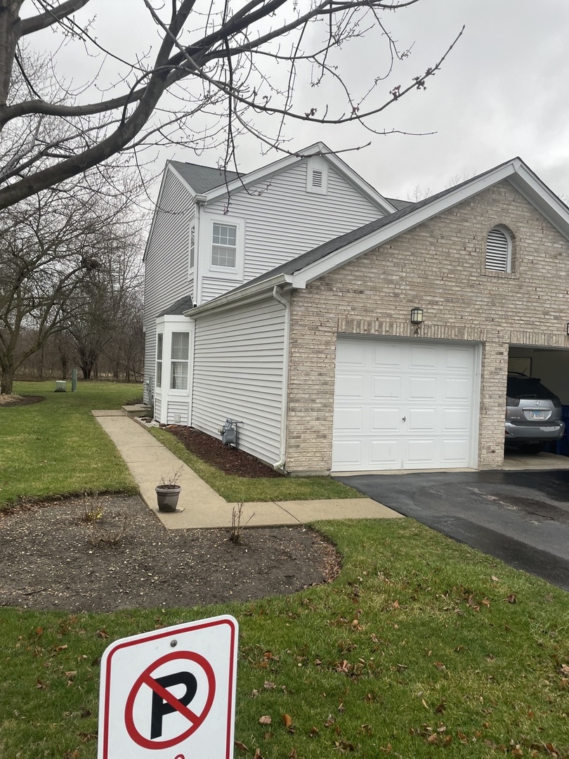498 Nicole Drive, Unit A Bartlett, IL 60103 - Photo 1 of 7 a view of a white house next to a yard and road