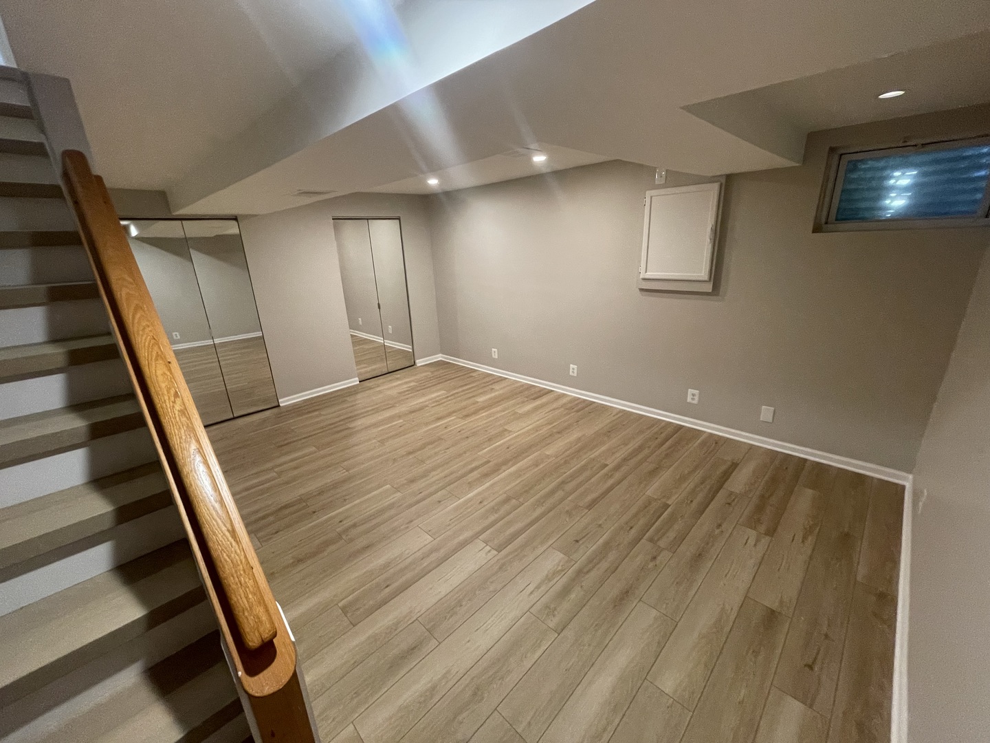 498 Nicole Drive, Unit A Bartlett, IL 60103 - Photo 5 of 7 a view of an empty room with wooden floor and stairs