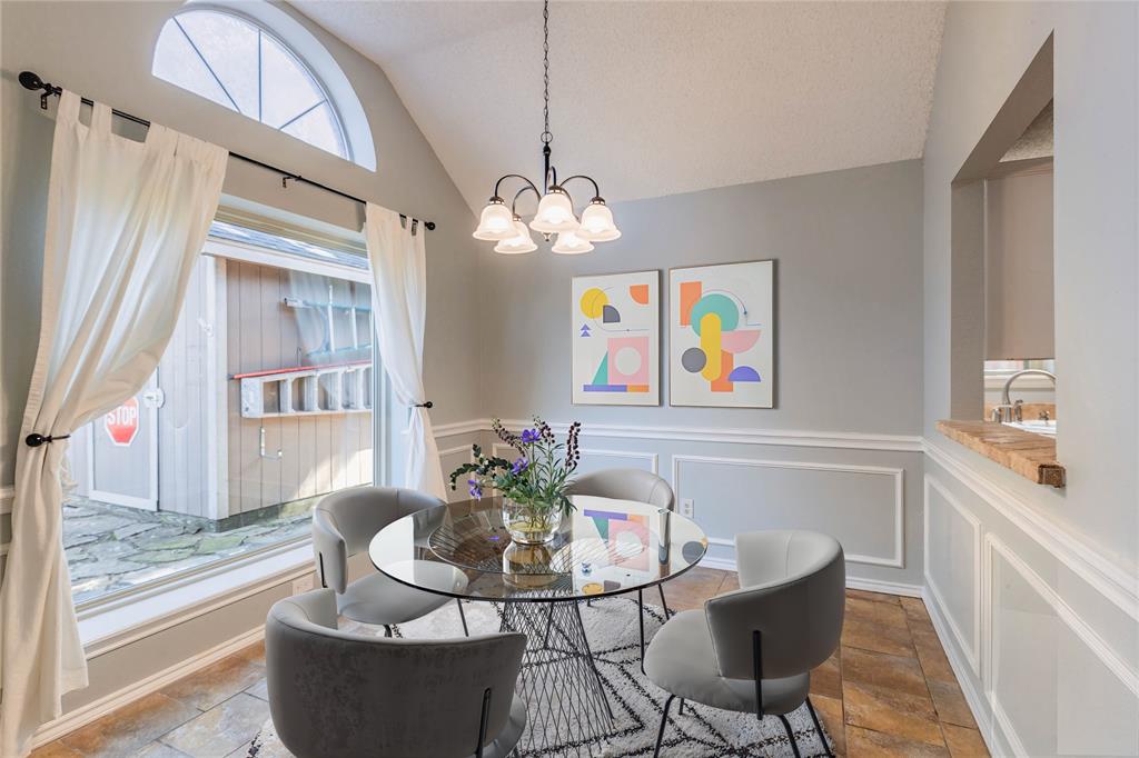 2123 Ridgecliff Drive Keller, TX 76248 - Photo 3 of 19 a dining room with furniture a rug a potted plant and a chandelier