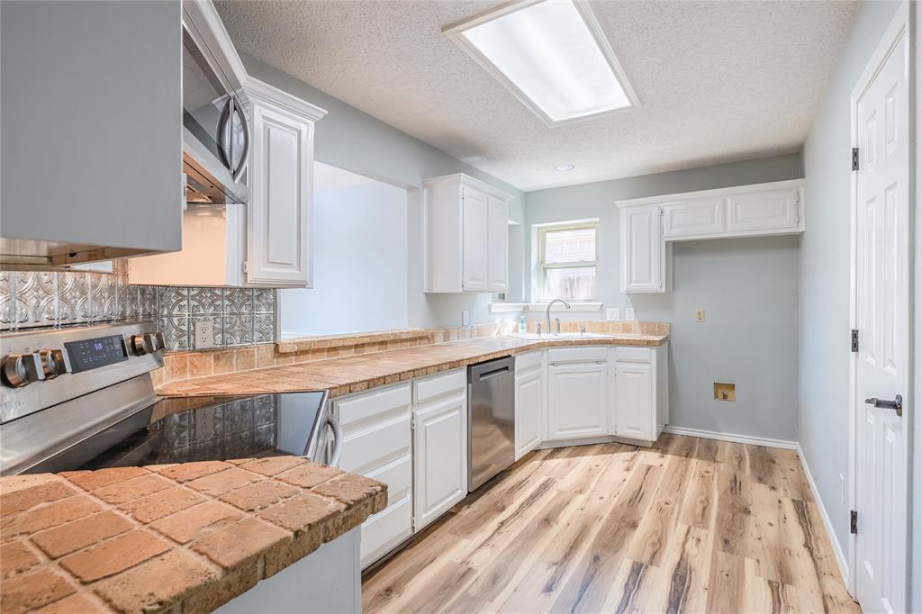 2123 Ridgecliff Drive Keller, TX 76248 - Photo 5 of 19 a kitchen with a sink stove and cabinets