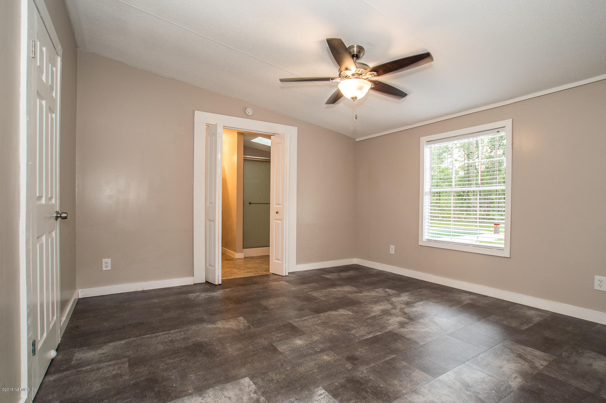 8980 Trail Ridge Road Jacksonville, FL 32234 - Photo 14 of 37 a view of a livingroom with a ceiling fan and window