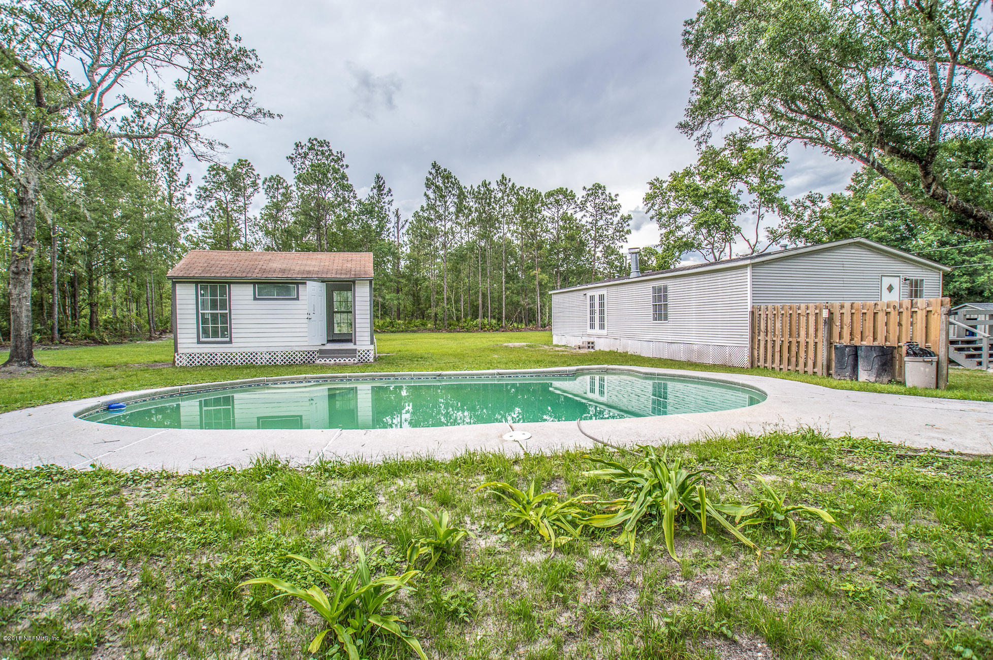 8980 Trail Ridge Road Jacksonville, FL 32234 - Photo 23 of 37 a view of house with a big yard and large trees