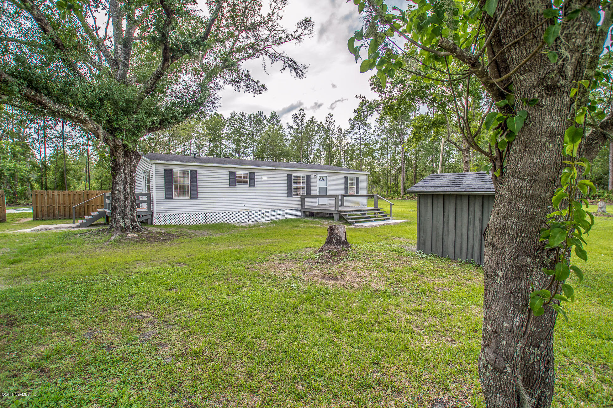 8980 Trail Ridge Road Jacksonville, FL 32234 - Photo 3 of 37 a view of a house with a backyard and a tree