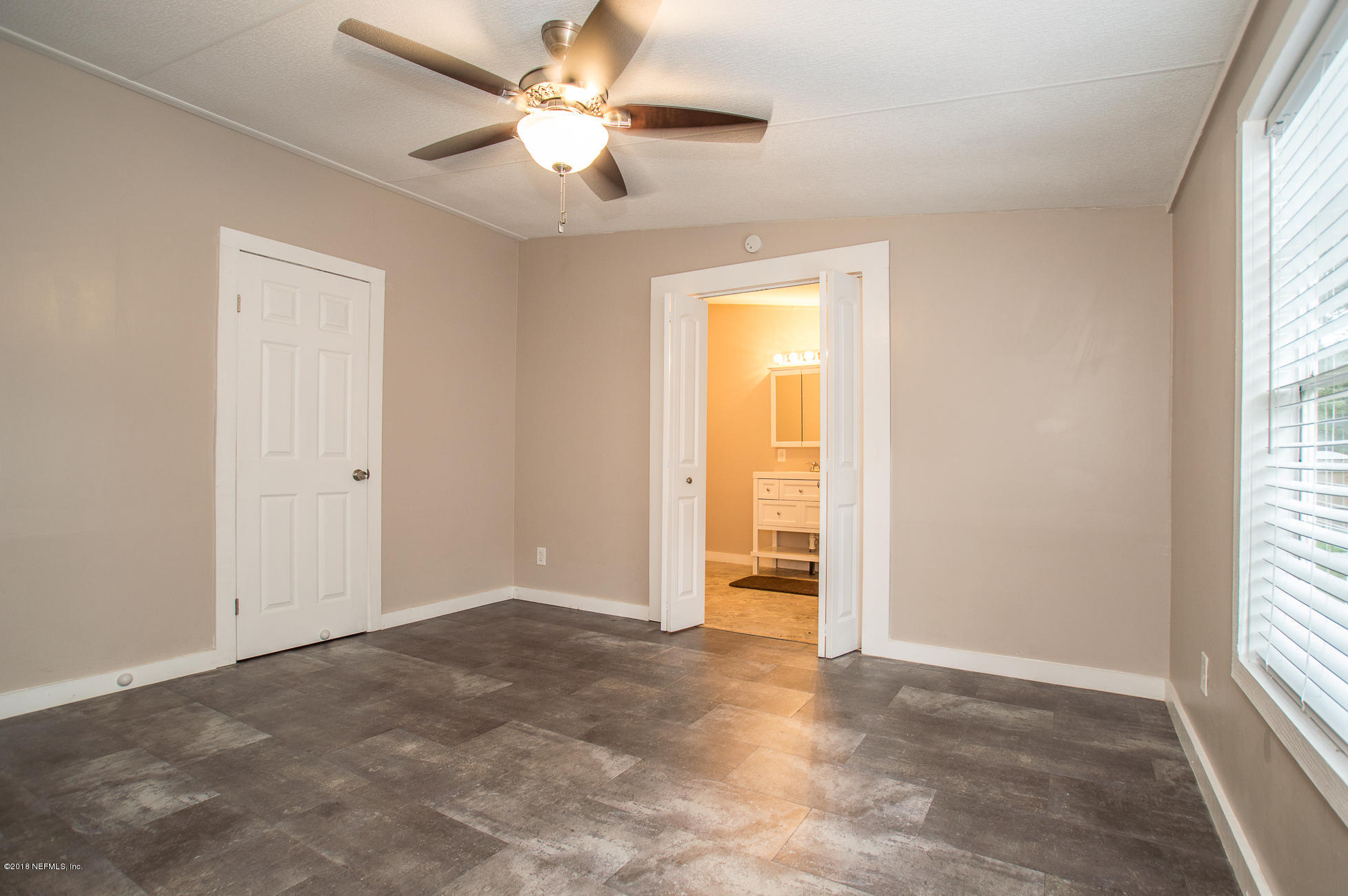 8980 Trail Ridge Road Jacksonville, FL 32234 - Photo 7 of 37 an empty room with windows and fan