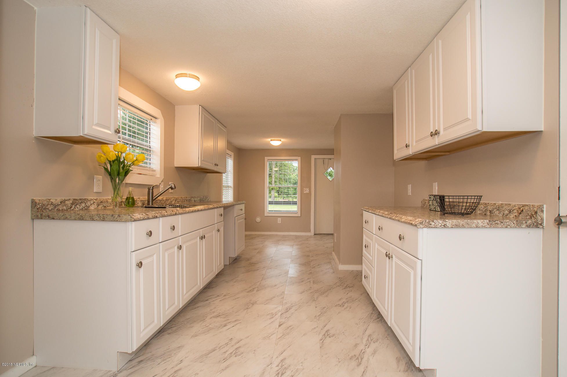 8980 Trail Ridge Road Jacksonville, FL 32234 - Photo 8 of 37 a kitchen with granite countertop a sink stove and cabinets