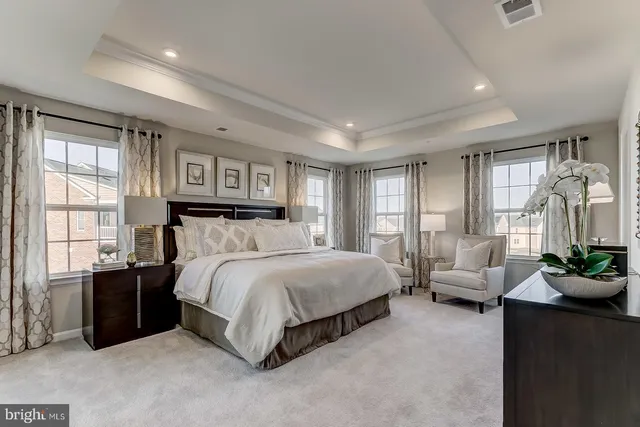 a spacious bedroom with a bed and a couch