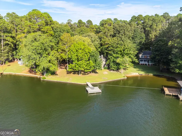 a swimming pool with some trees in the background