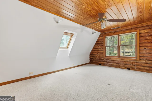 a living room filled with furniture windows and a fireplace
