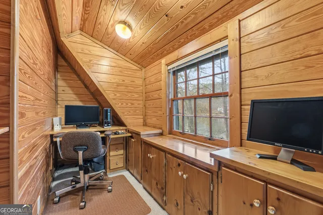 a view of a lake with boats and trees all around
