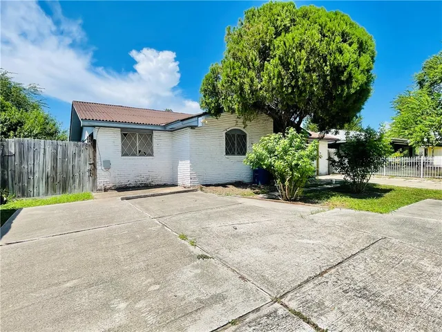 a house with a yard and a wooden fence