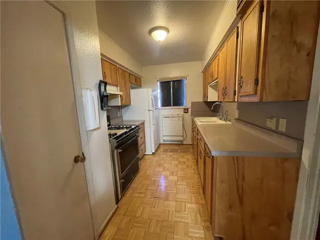 a kitchen with a sink appliances and cabinets