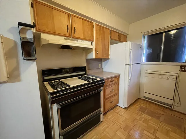 a kitchen with a stove and a refrigerator