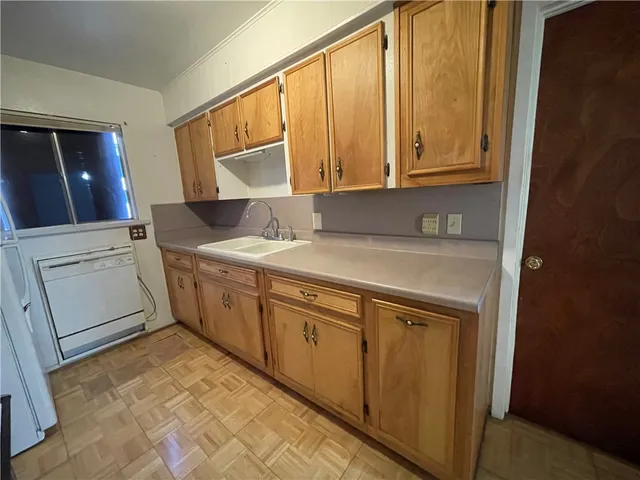a utility room with granite countertop cabinets washer and dryer