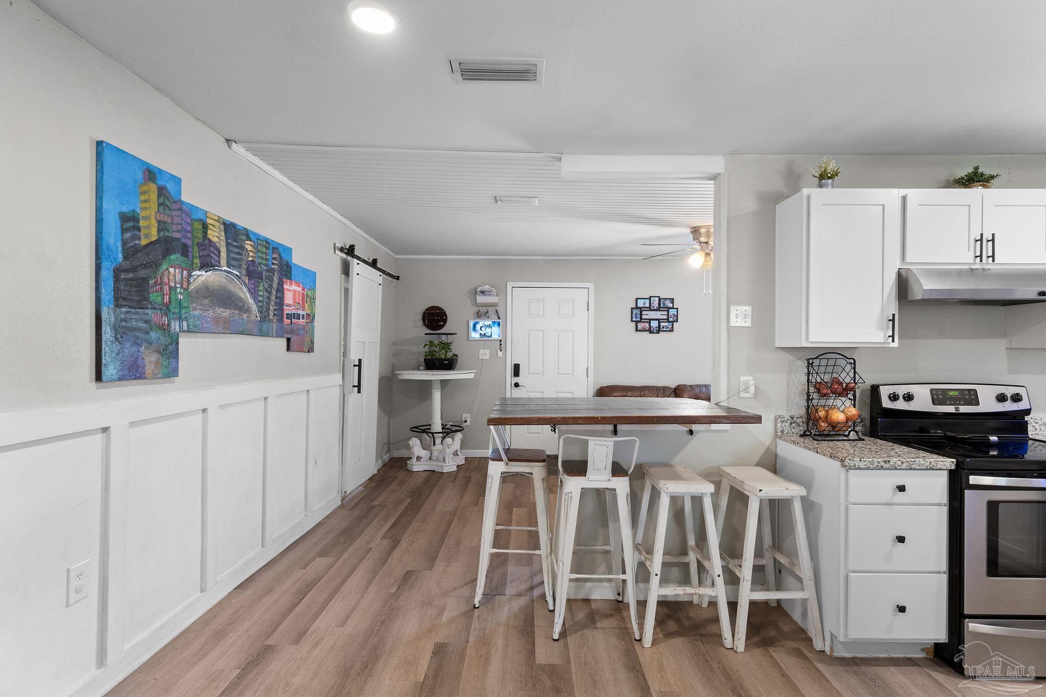 10610 Chemstrand Road Pensacola, FL 32514 - Photo 12 of 42 a view of a kitchen with furniture and wooden floor