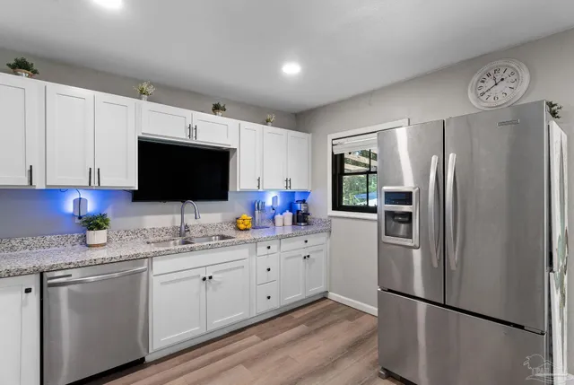 a kitchen with stainless steel appliances a refrigerator microwave and sink