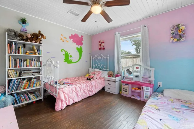 a bedroom with bed and a book shelf