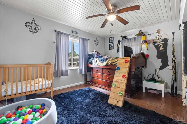 a bedroom with furniture and a baby crib