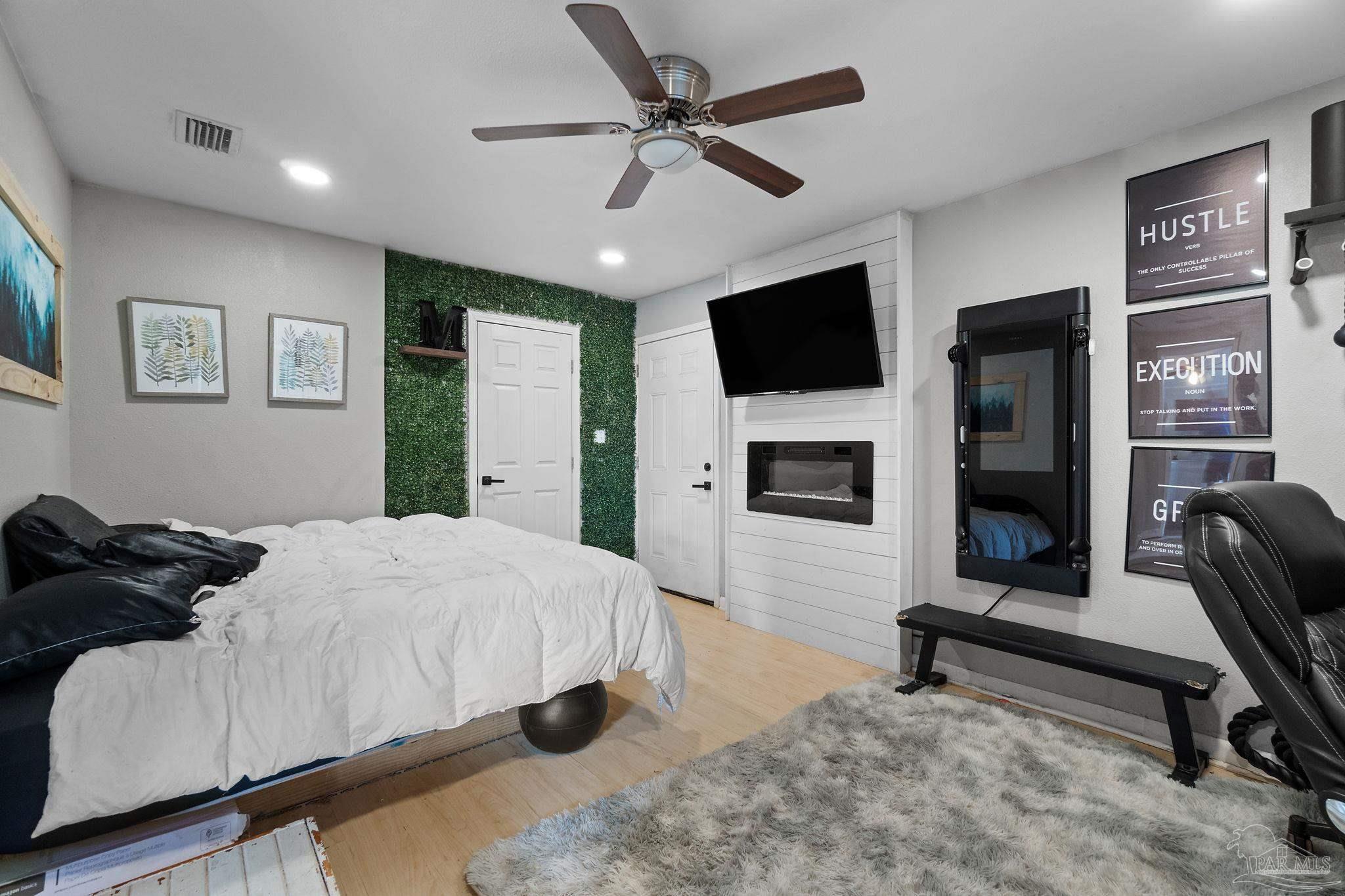 10610 Chemstrand Road Pensacola, FL 32514 - Photo 22 of 42 a bedroom with a bed window and a flat screen tv