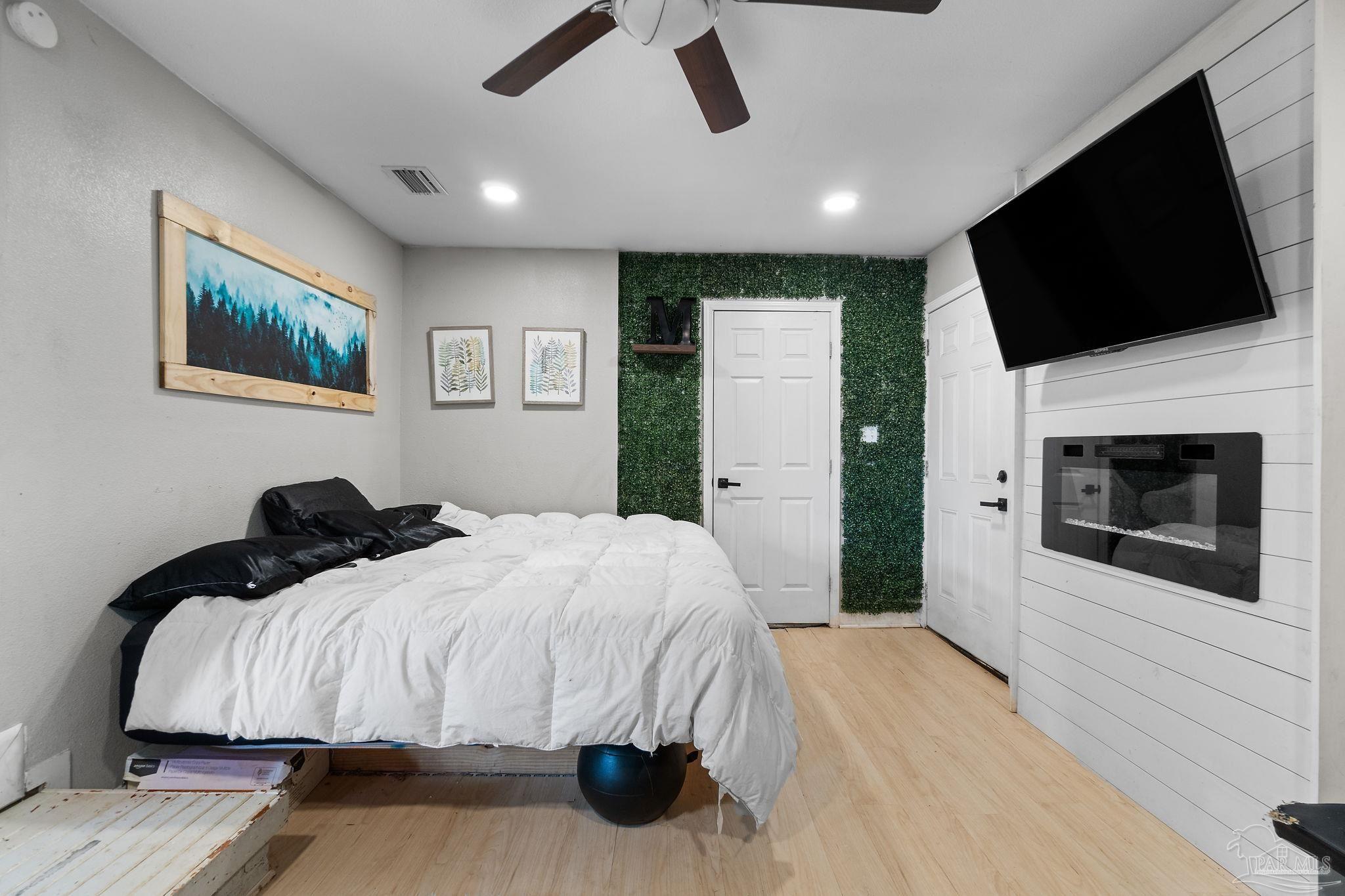 10610 Chemstrand Road Pensacola, FL 32514 - Photo 23 of 42 a bedroom with a bed and a flat screen tv