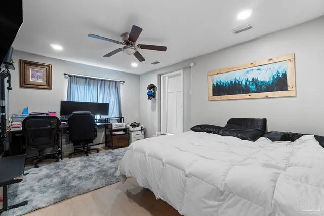 a bedroom with bed window and couch