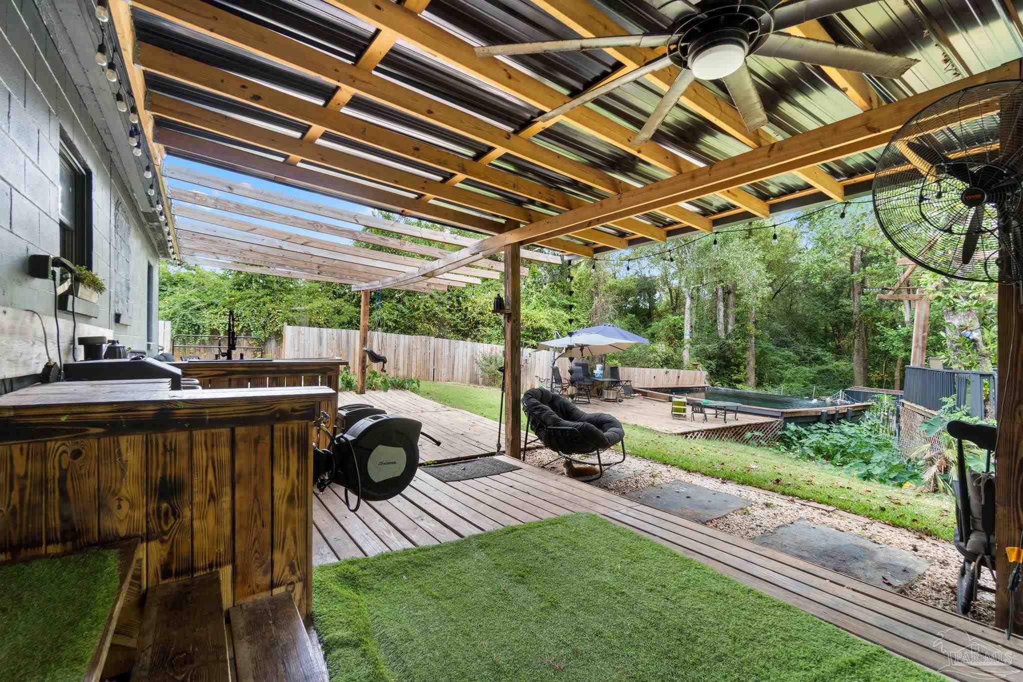 10610 Chemstrand Road Pensacola, FL 32514 - Photo 29 of 42 a view of a backyard with couches plants and large trees