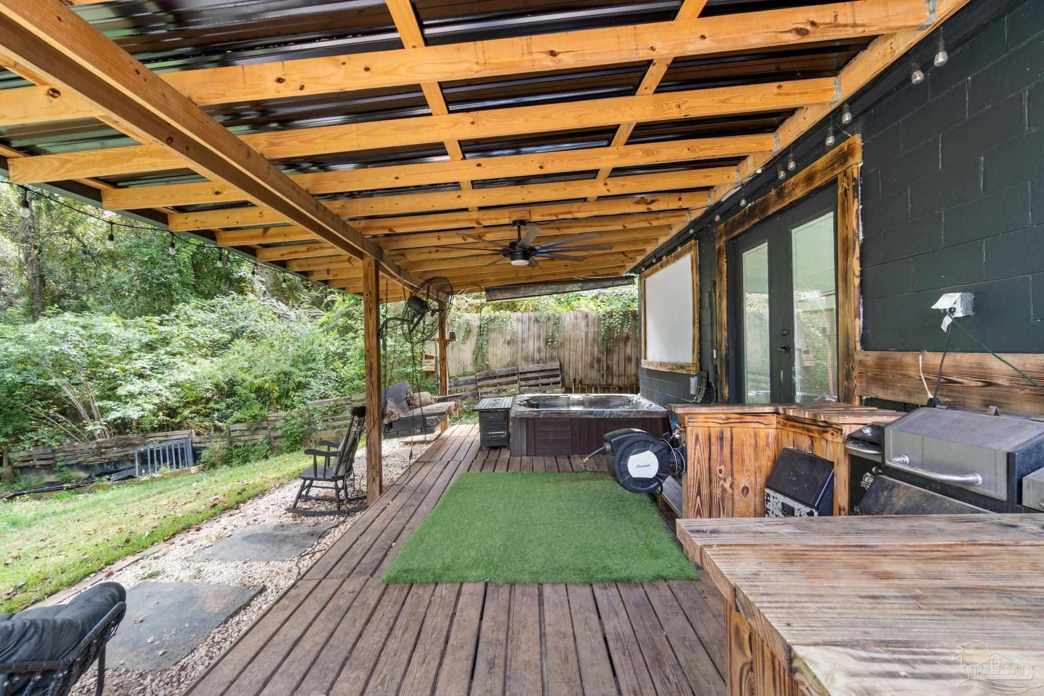 10610 Chemstrand Road Pensacola, FL 32514 - Photo 30 of 42 a patio with wooden floors and outdoor seating