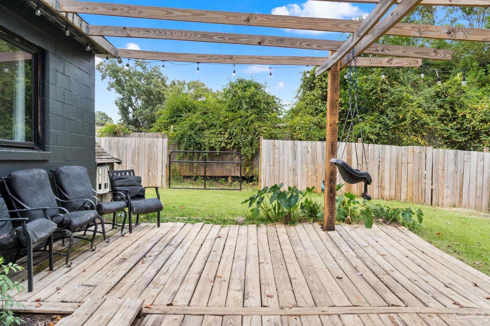 10610 Chemstrand Road Pensacola, FL 32514 - Photo 32 of 42 a view of backyard with table and chairs and wooden fence