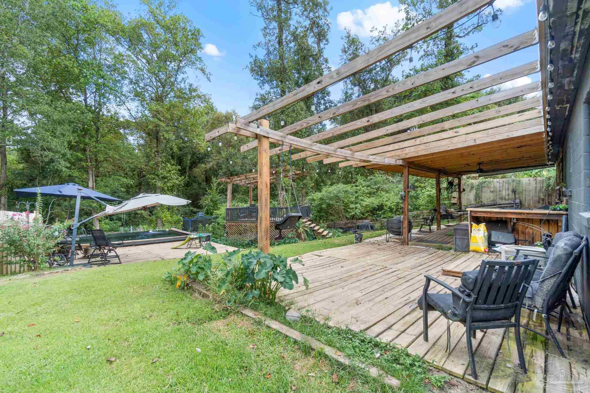 10610 Chemstrand Road Pensacola, FL 32514 - Photo 33 of 42 a patio with a yard table and chairs