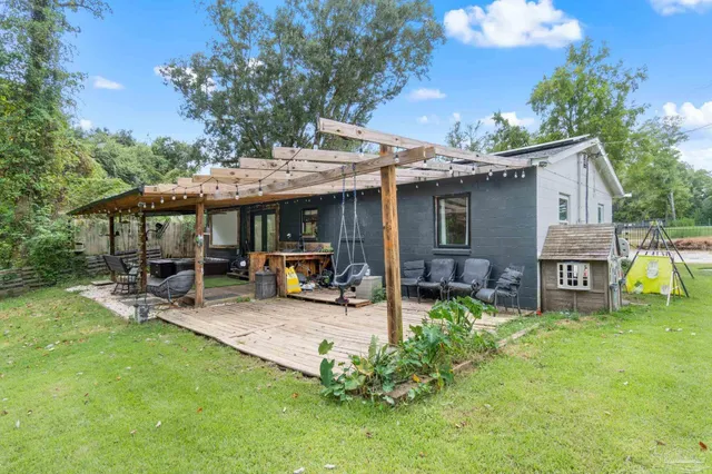 a view of a house with backyard porch and sitting area