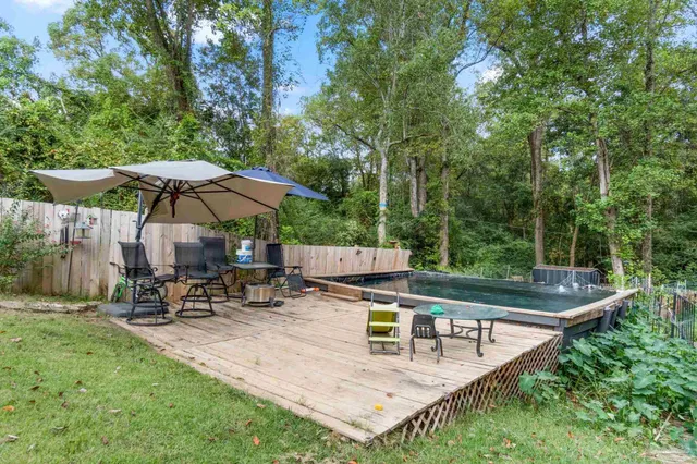 a view of backyard with sitting area and umbrella