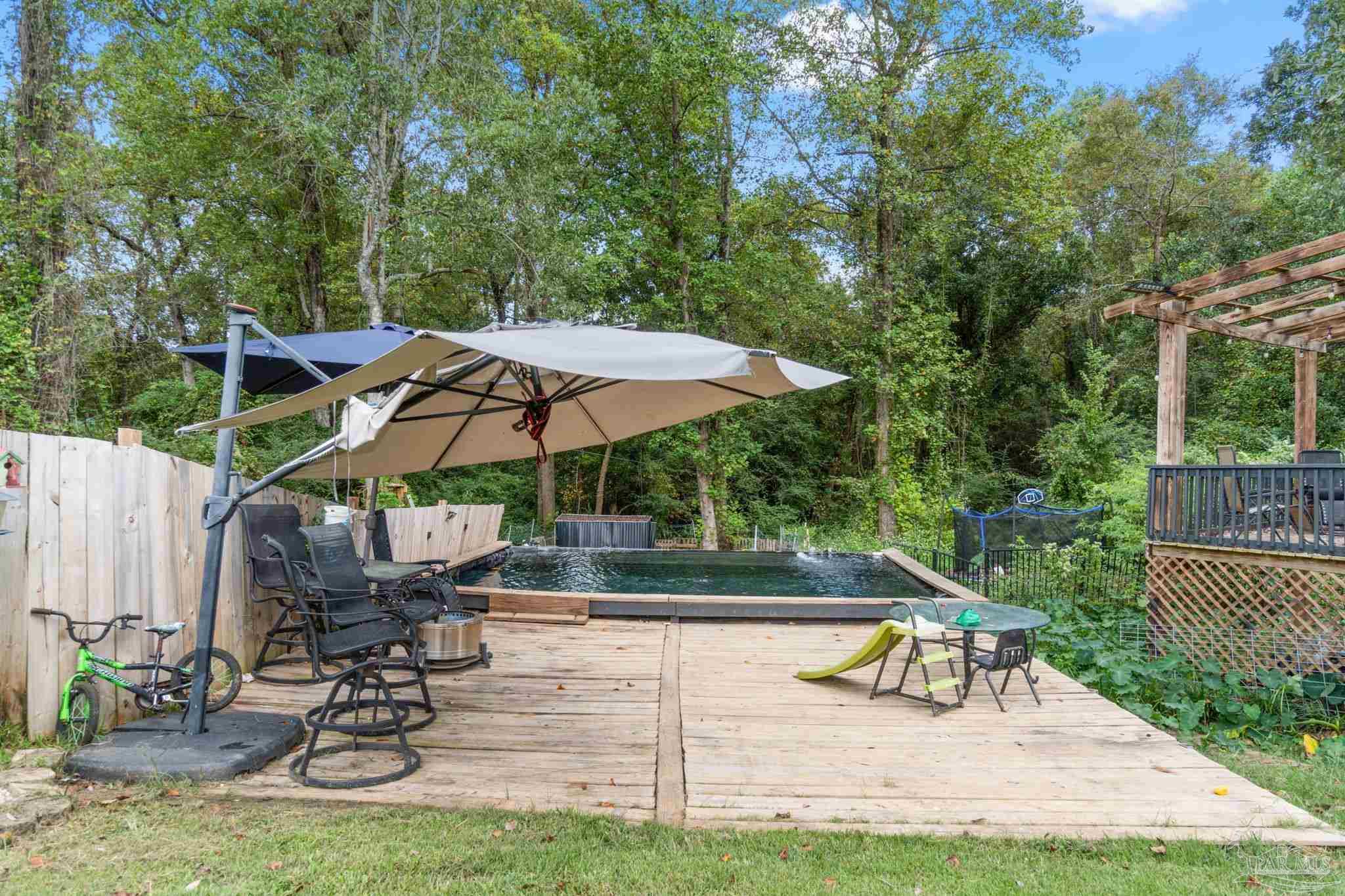 10610 Chemstrand Road Pensacola, FL 32514 - Photo 37 of 42 a view of backyard with swimming pool and sitting area