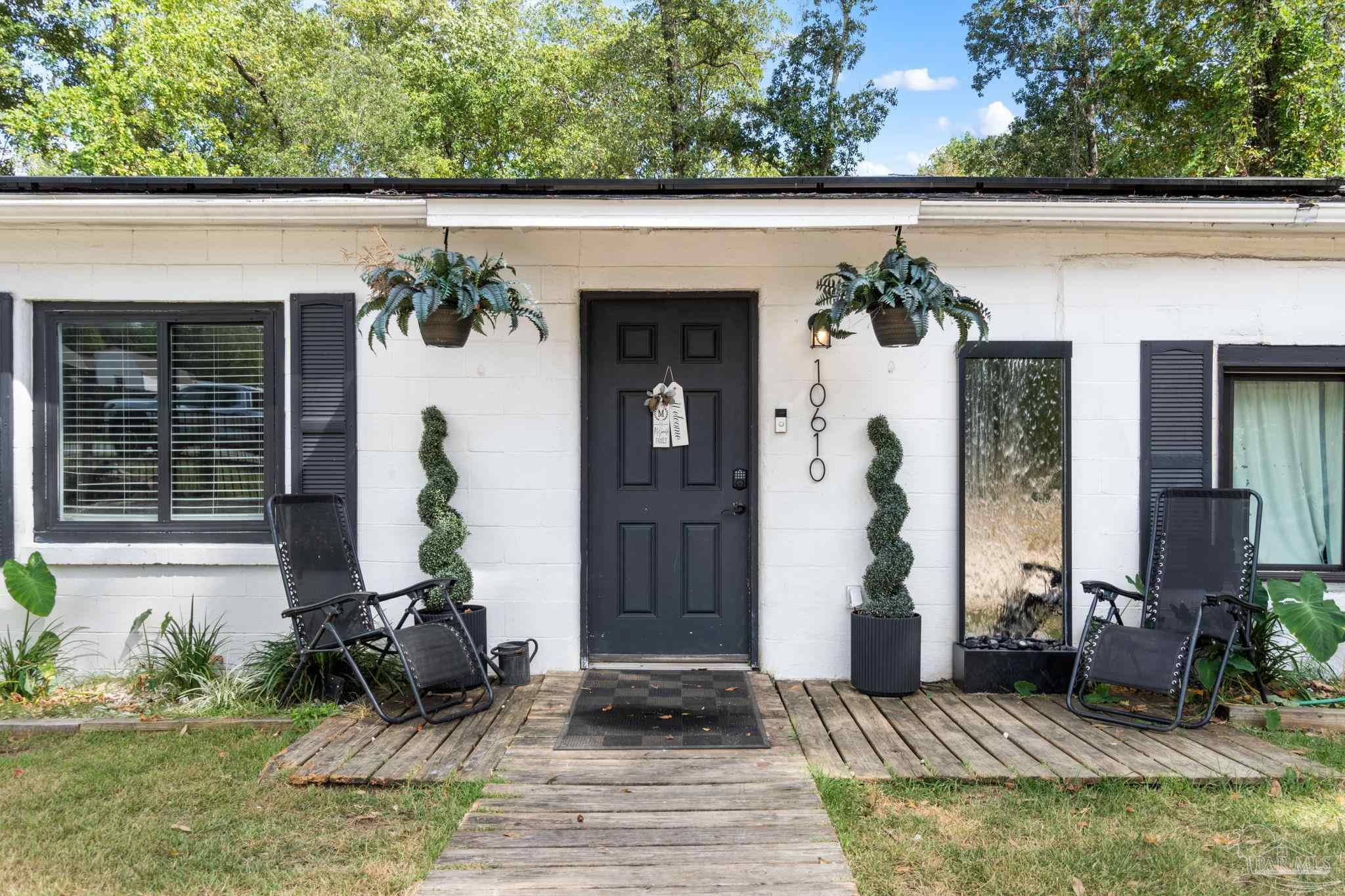 10610 Chemstrand Road Pensacola, FL 32514 - Photo 4 of 42 a front view of a house with garden