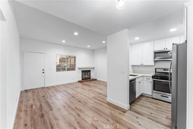 a view of kitchen with sink and refrigerator