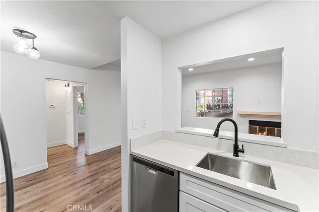 a kitchen with a sink and a mirror