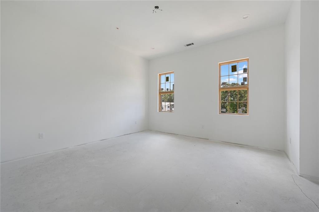 8200 Main Street, Unit 1306 Woodstock, GA 30188 - Photo 12 of 43 an empty room with windows