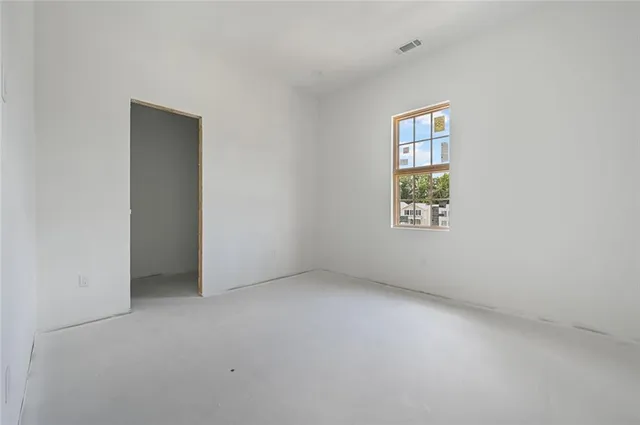 an empty room with windows and closet